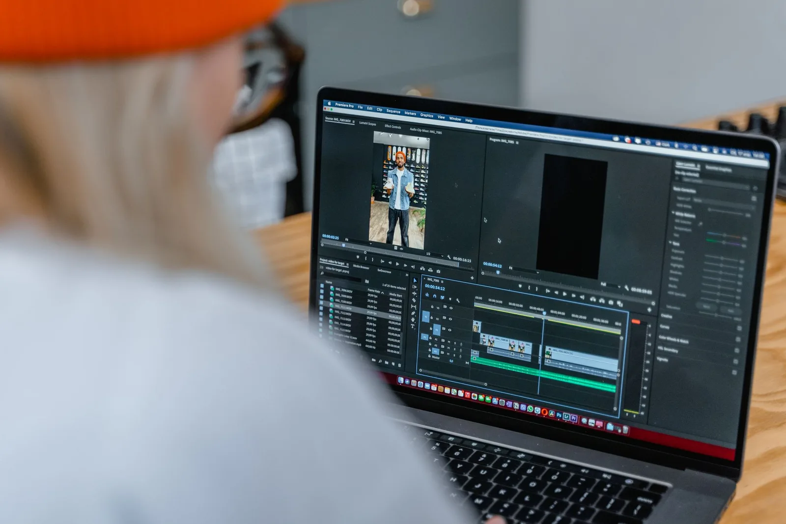 Laptop screen-এ video editing timeline ও preview দেখা যাচ্ছে